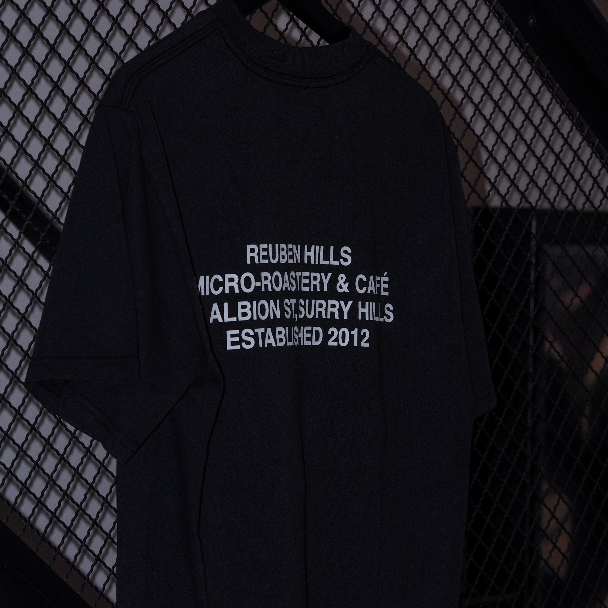 Black t-shirt with white text on a textured black background